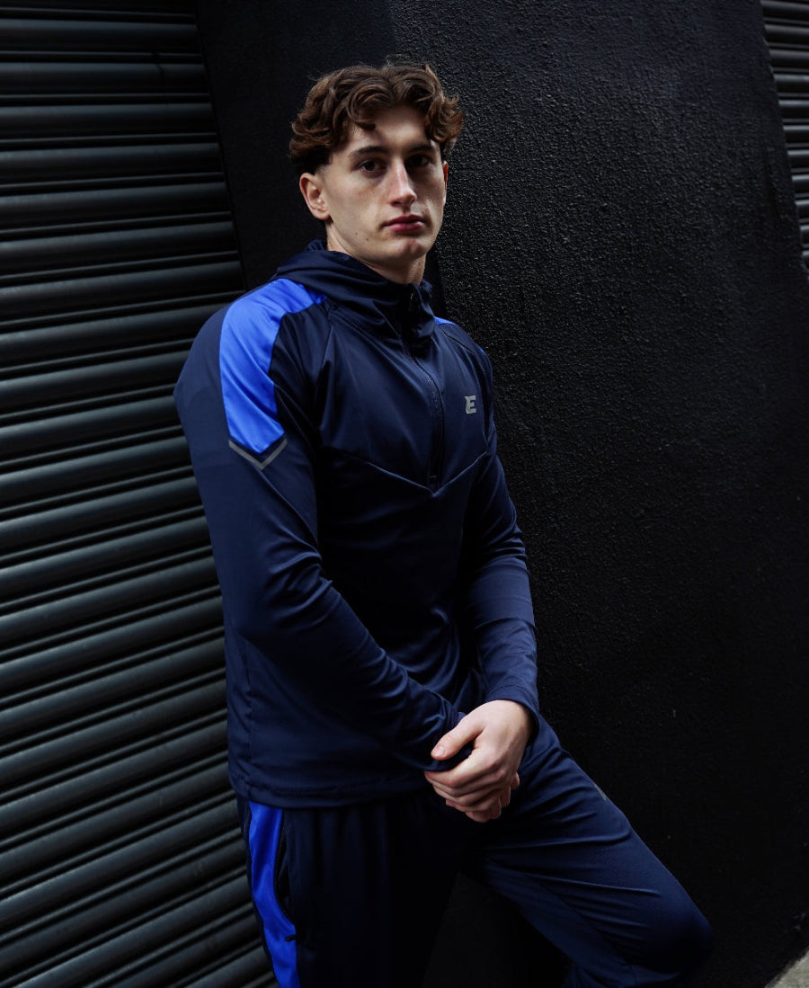 man wearing blue and navy sports tracksuit