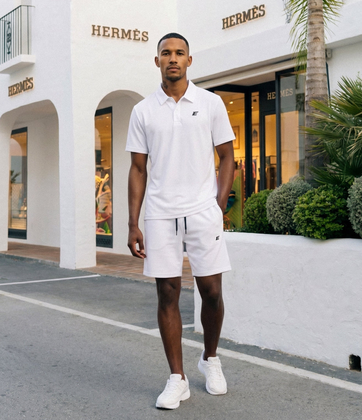 man wearing white polo shirt and shorts set, New Menswear outside a building