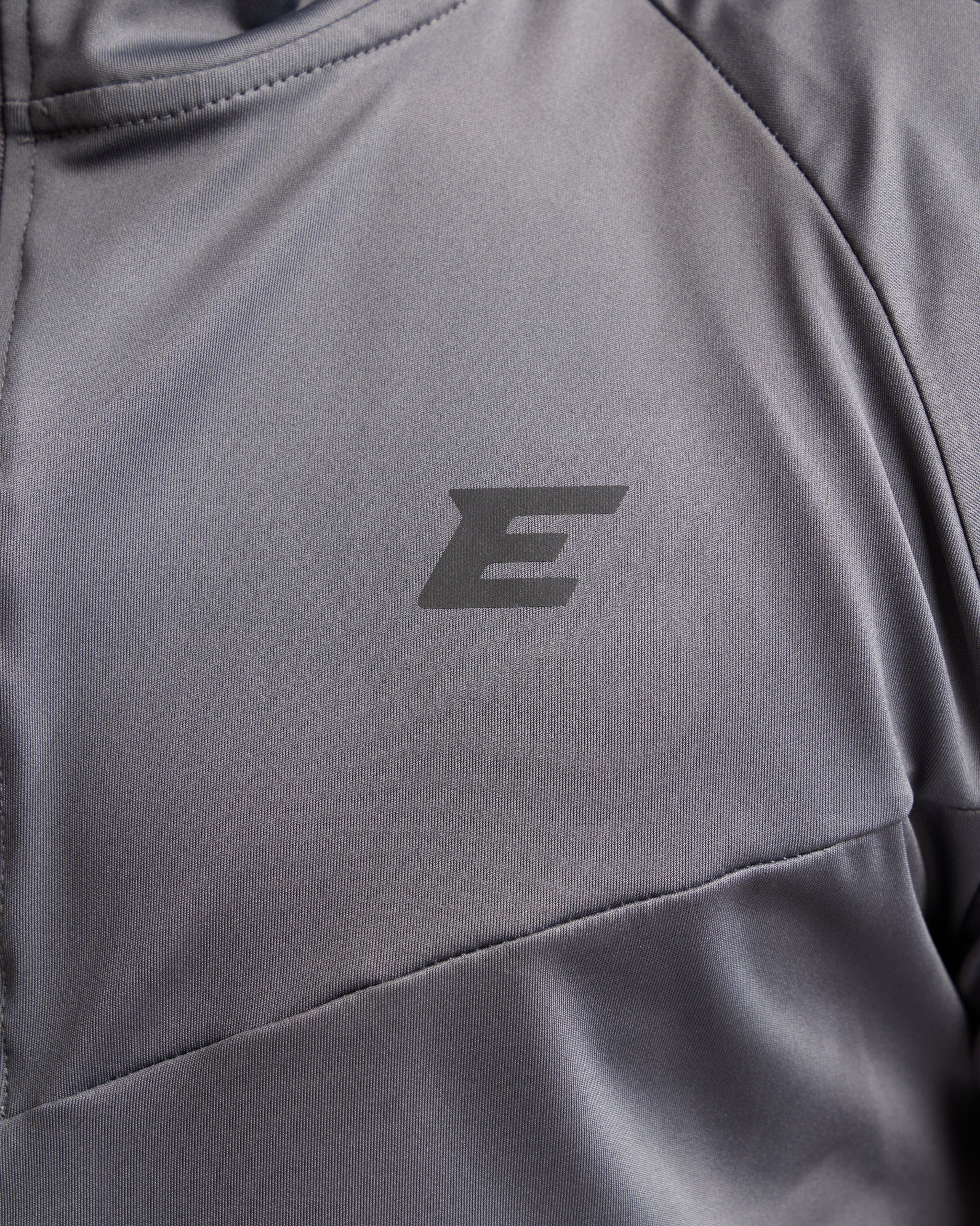 Gray athletic jacket with a logo on the chest