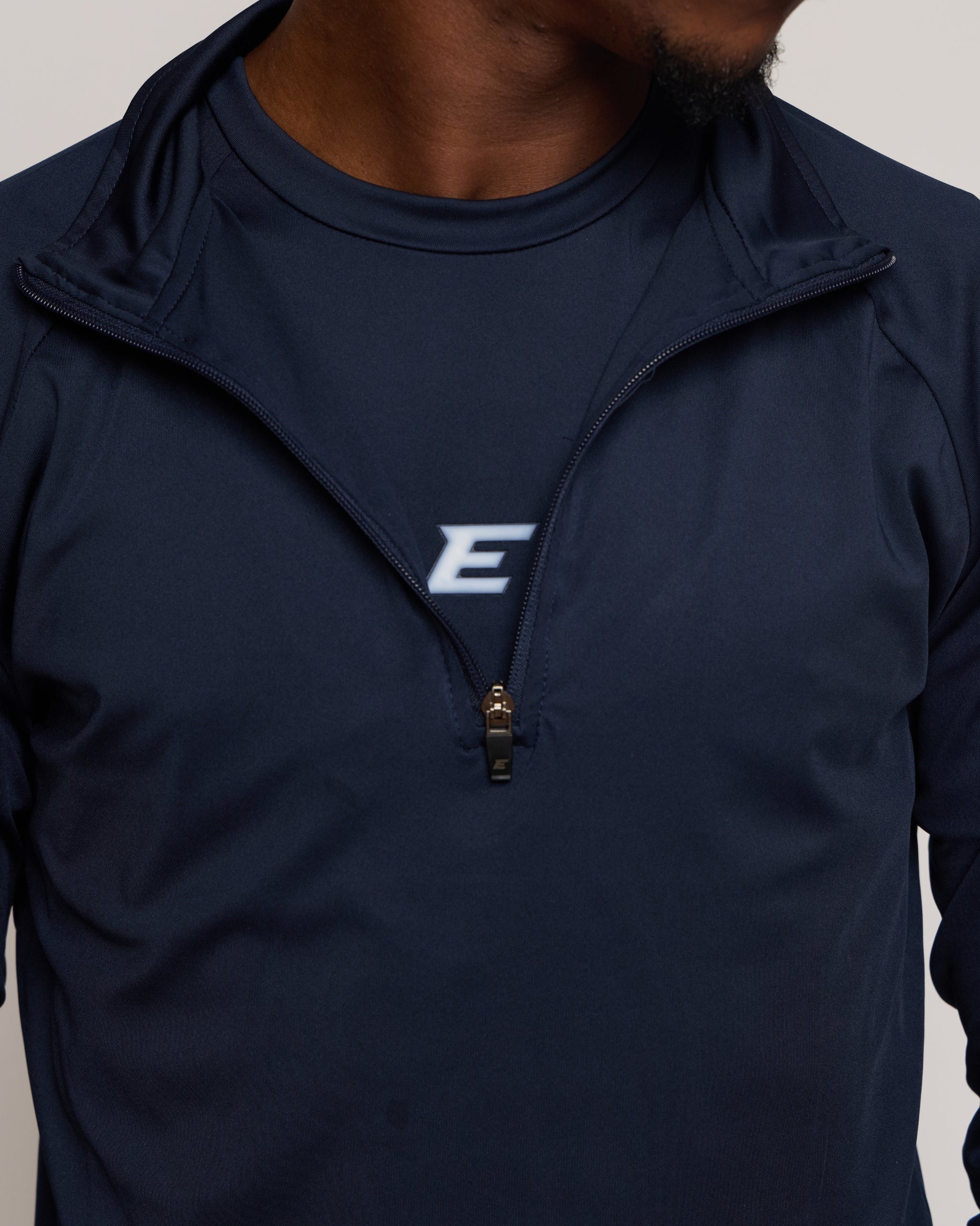 Navy blue zip jacket with a 'E' brand logo on a neutral background