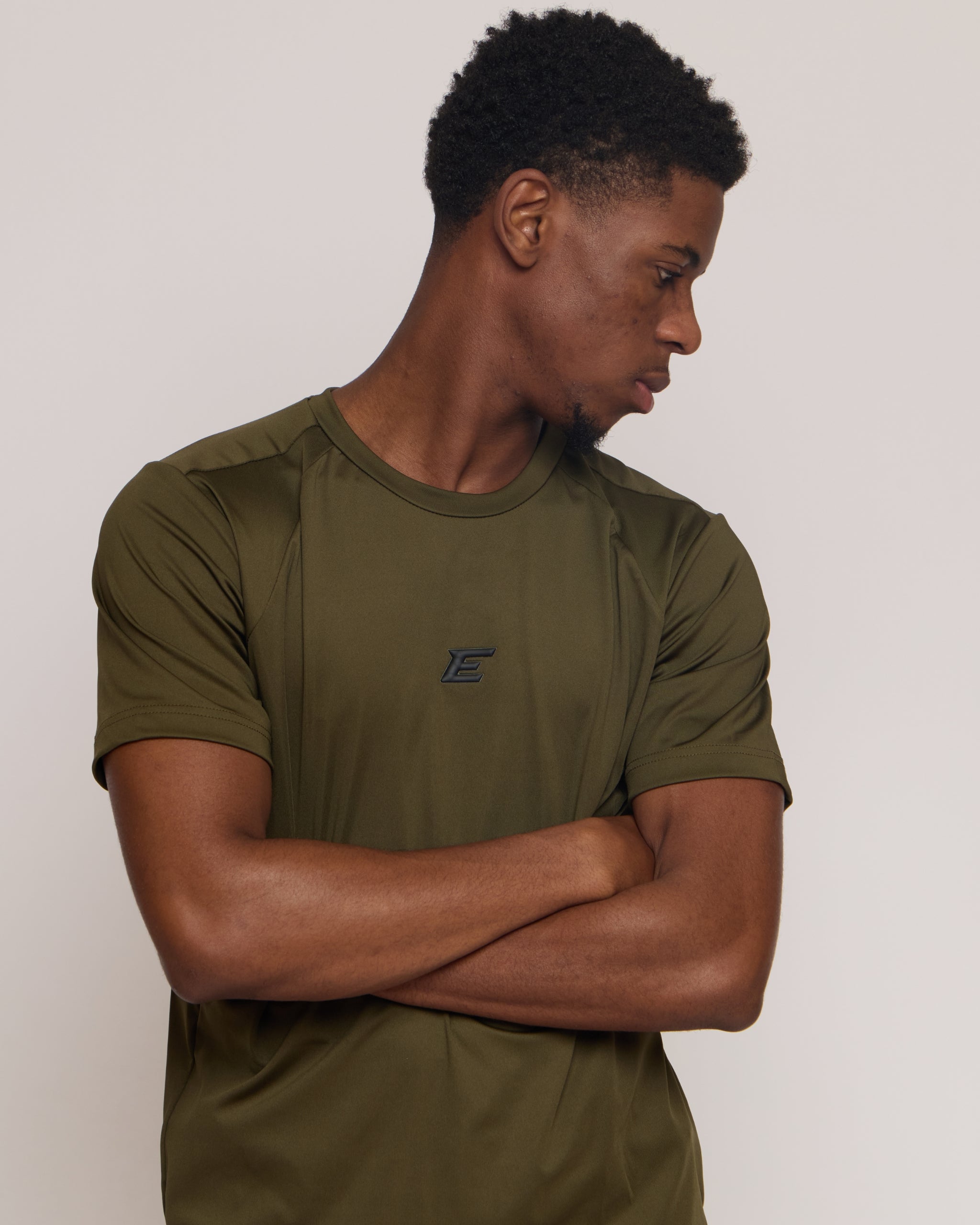 Man wearing a green khaki athletic t-shirt with 'e' logo on white background