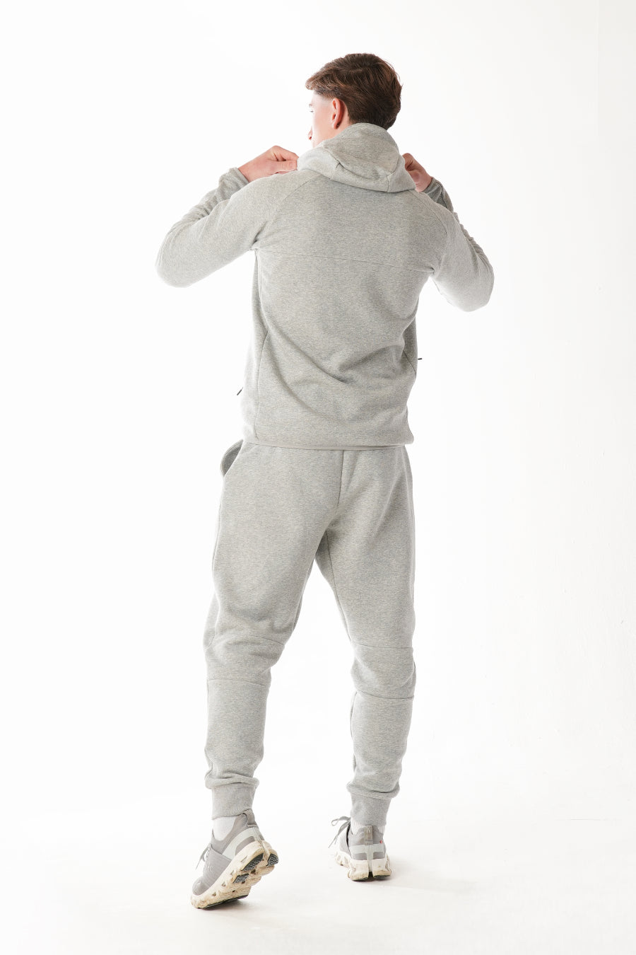 Man wearing Hazel Grey tracksuit on white background
