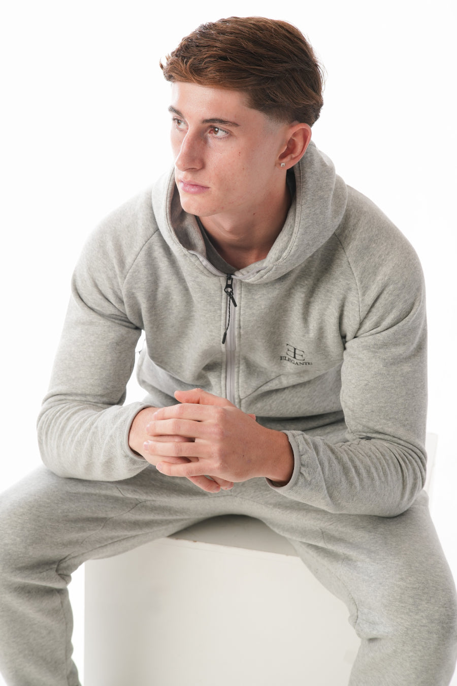 Man wearing Hazel Grey tracksuit on white background