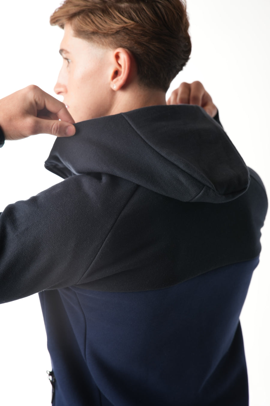 Man wearing midnight blue navy Tracksuit on white background