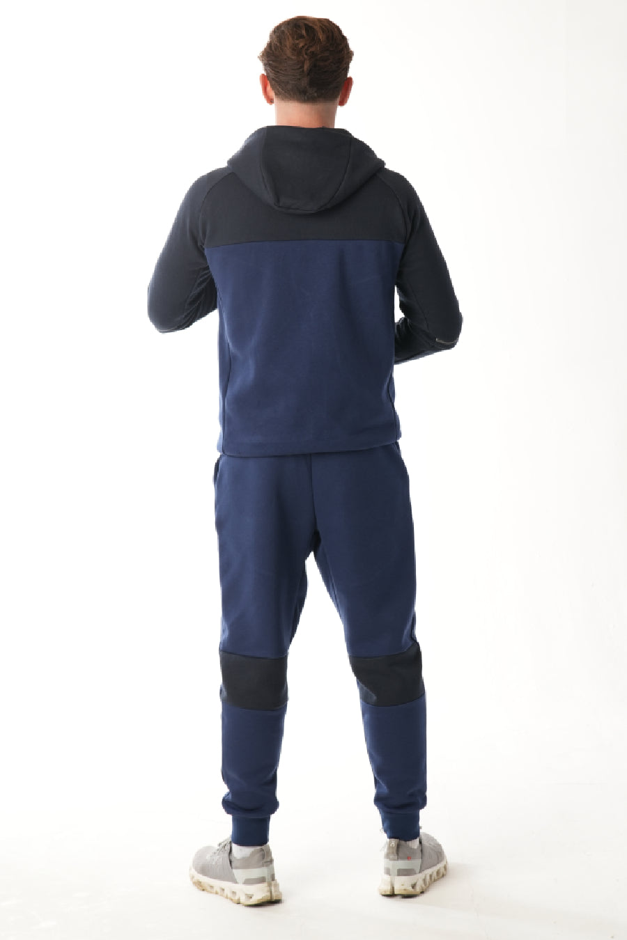 Man wearing midnight blue navy Tracksuit on white background