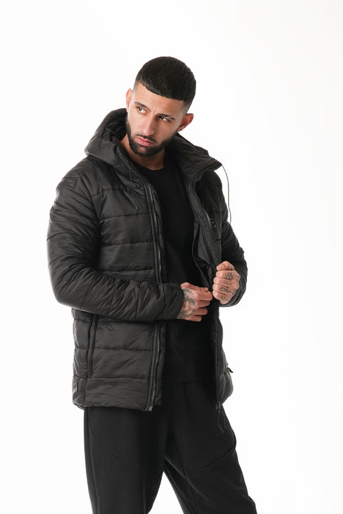 Man wearing a black puffer jacket on a white background