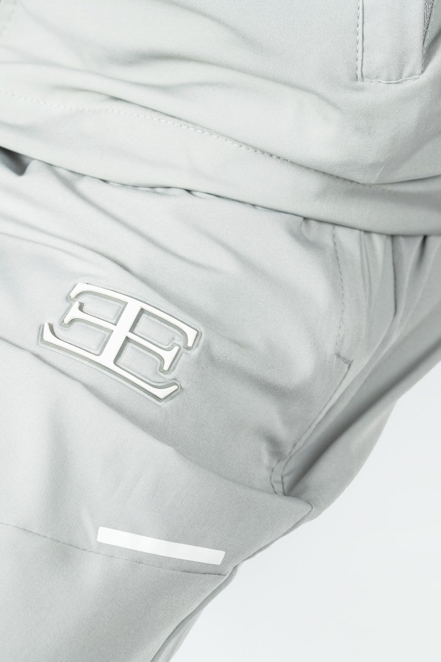 close up of Gray tracksuit with a elegante logo on a white background