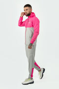 man wearing pink and grey tracksuit with a elegante logo on a white background