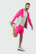 man wearing pink and grey tracksuit jackets with pink shorts with a elegante logo on a white background