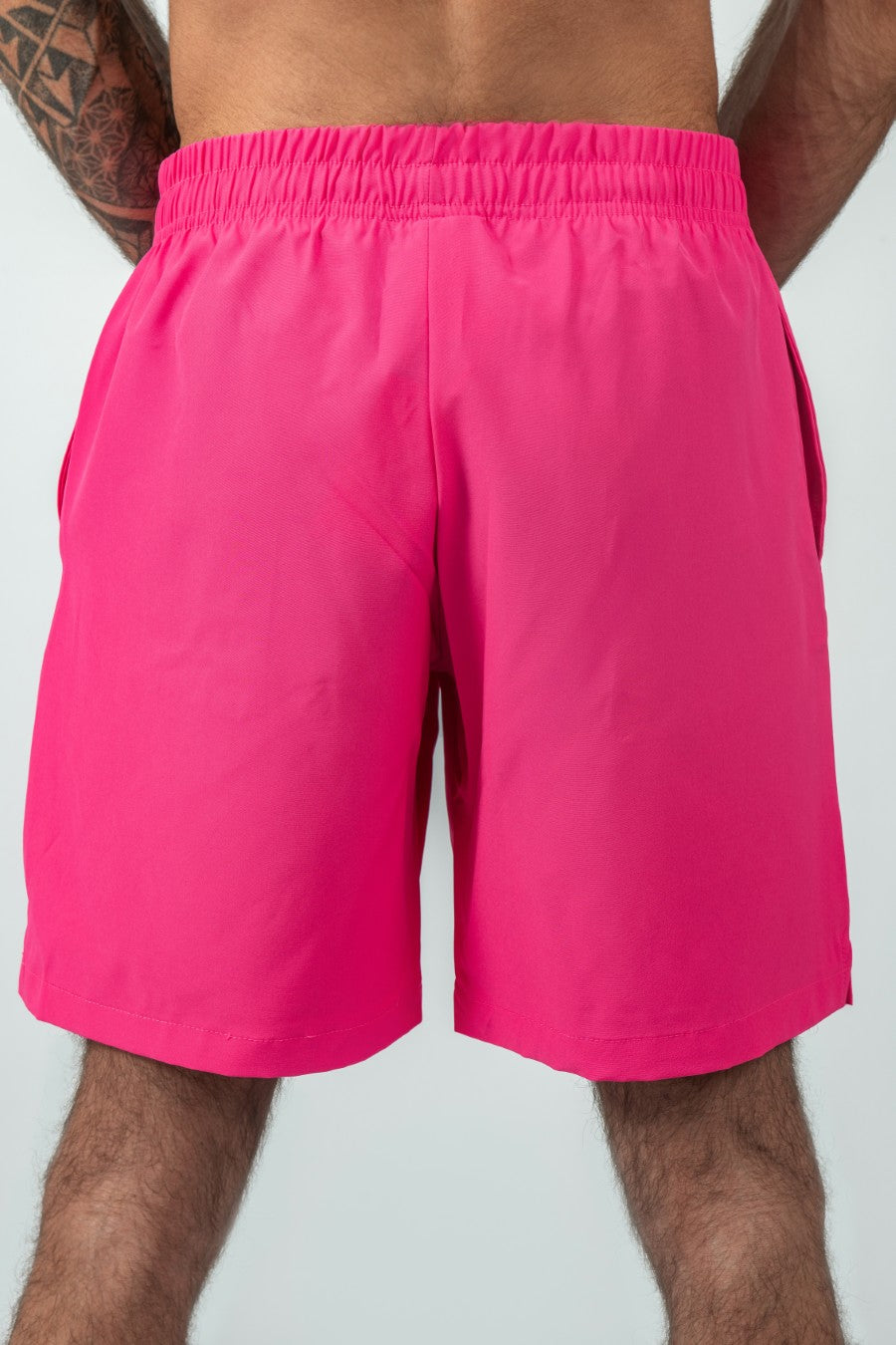 man wearing pink shorts on a white background
