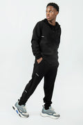 man wearing a black tracksuit with on a white background