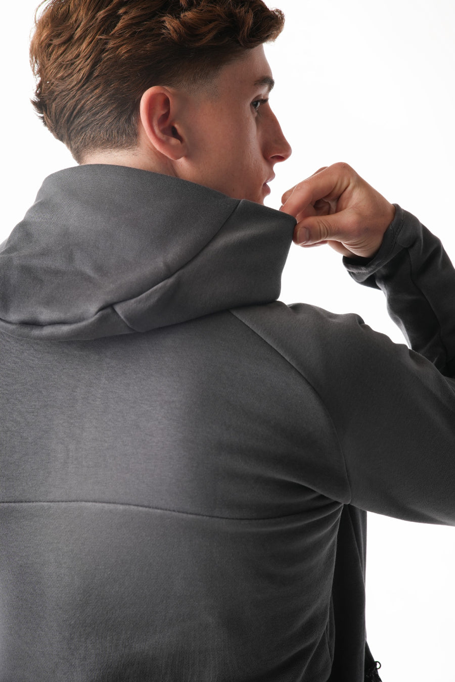 Person wearing a gray jacket on a white background