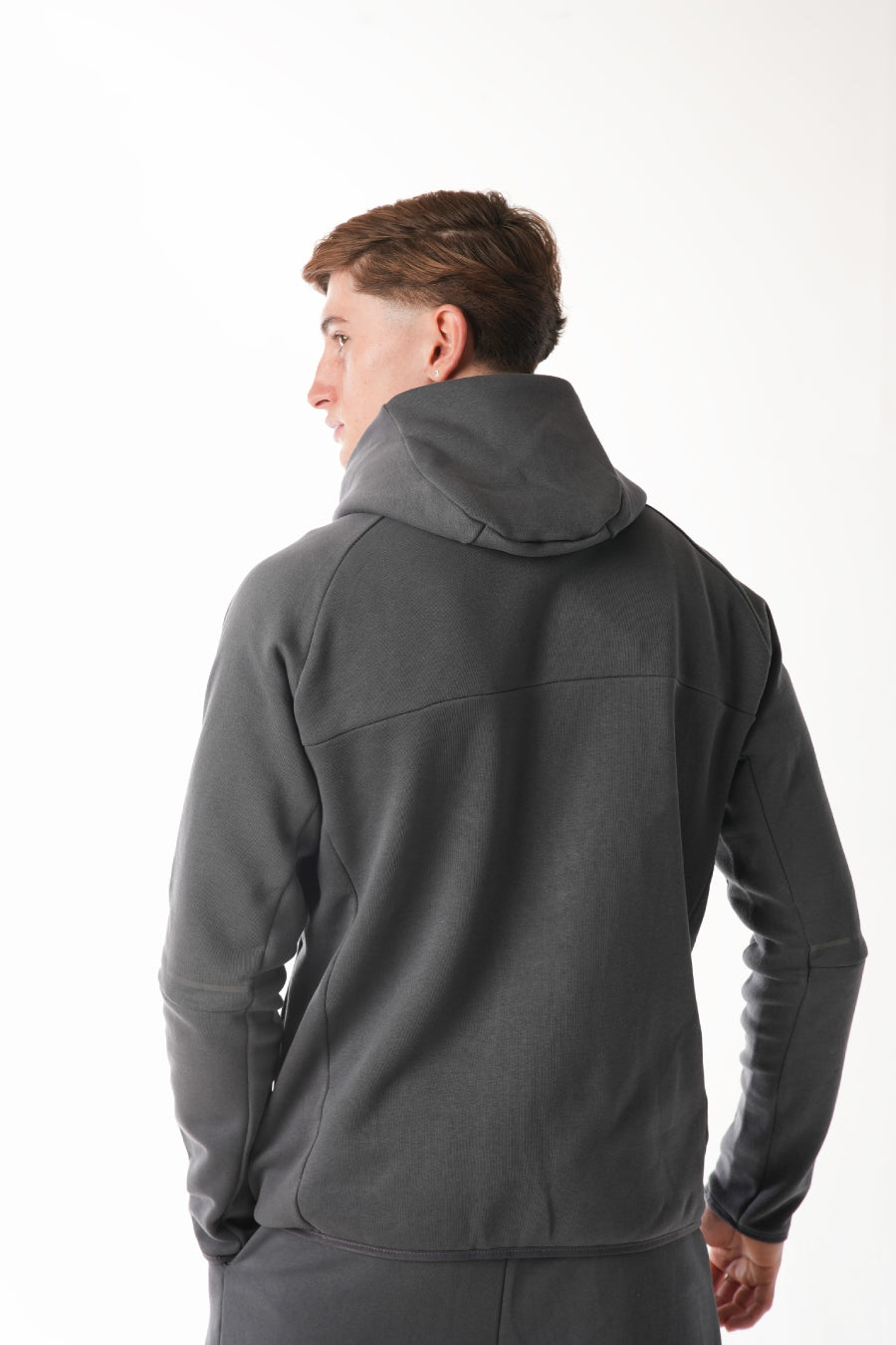 Person wearing a gray jacket on a white background