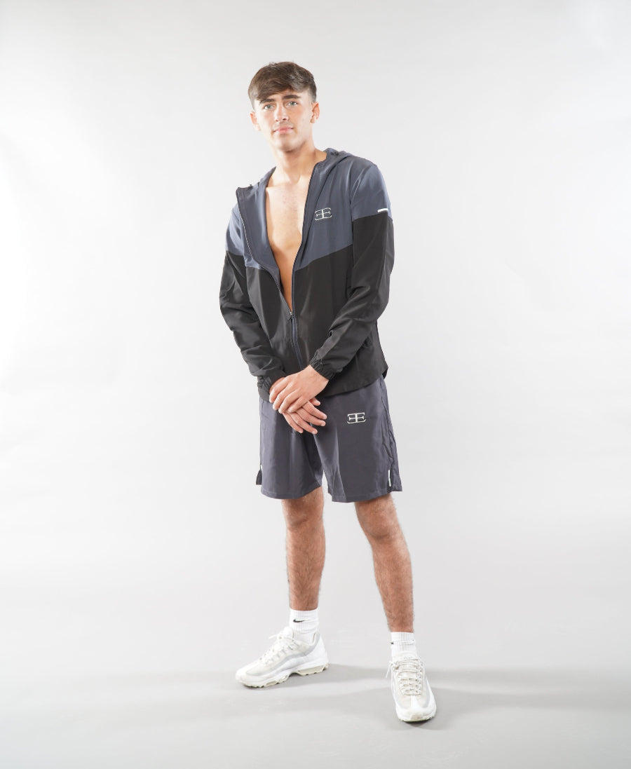 Man wearing Elegante grey Gym Shorts and tracksuit jacket, jacket unzipped and open