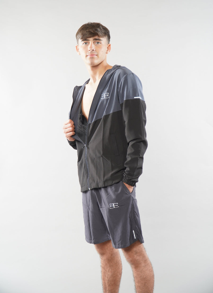 Man wearing Elegante grey Gym Shorts and tracksuit jacket, jacket unzipped and open