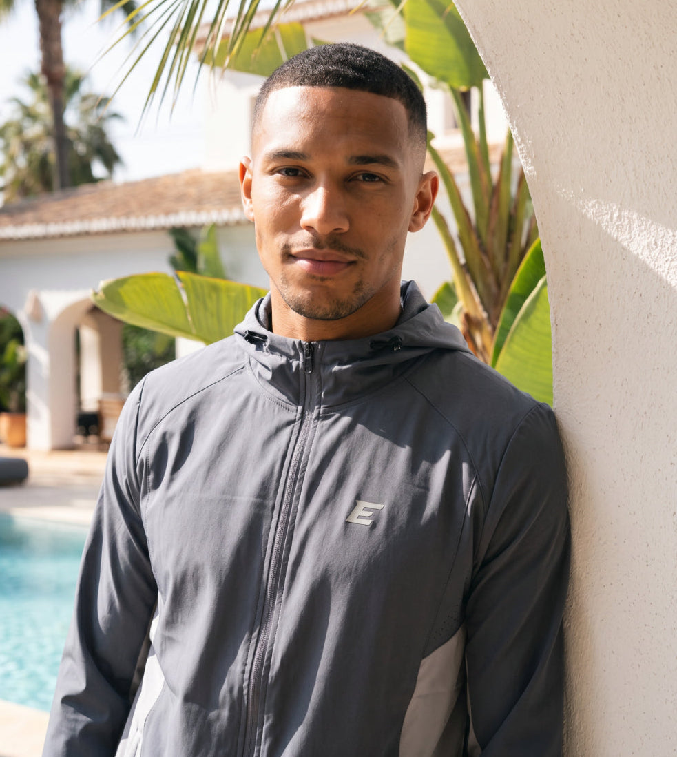 man wearing grey tracksuit in the sun