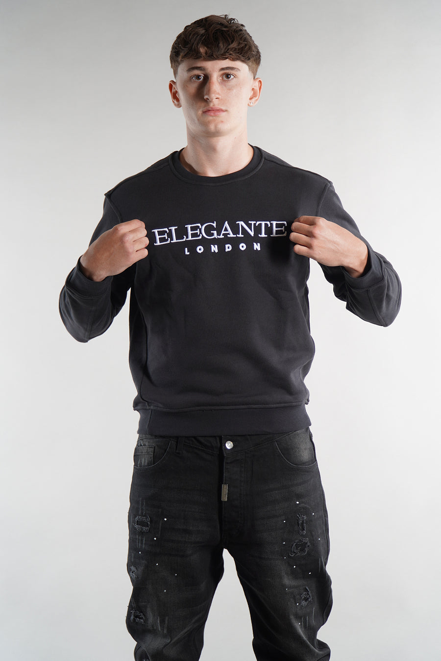 man wearing black jumper, with Elegante logo on the chest, designer sweatshirts, mens clothing