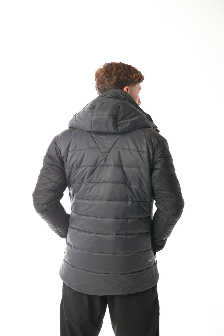 Person wearing a black puffer jacket on a white background