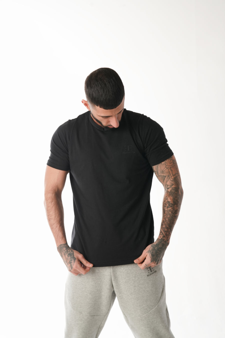 man wearing black sports tshirt on white background