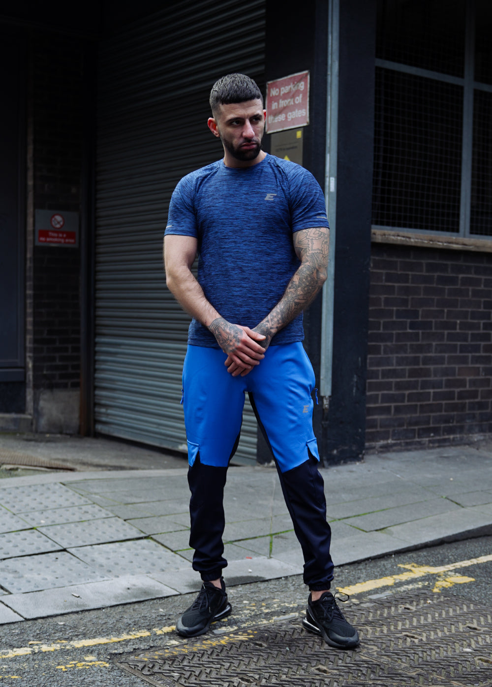 Man wearing blue athletic outfit in a city background