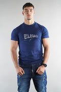man wearing Elegante logo T-Shirt in navy blue with denim jeans on white background