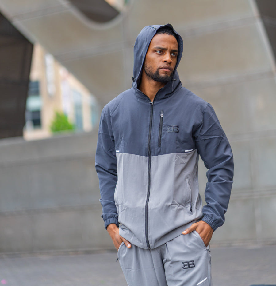 man wearing brand elegante, full tracksuits set with hood in colour grey, this is showing sportswear fashion 