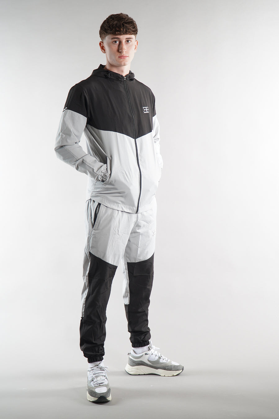 man wearing Elegante Black tracksuit jacket and joggers, tracksuit set activewear for men, 