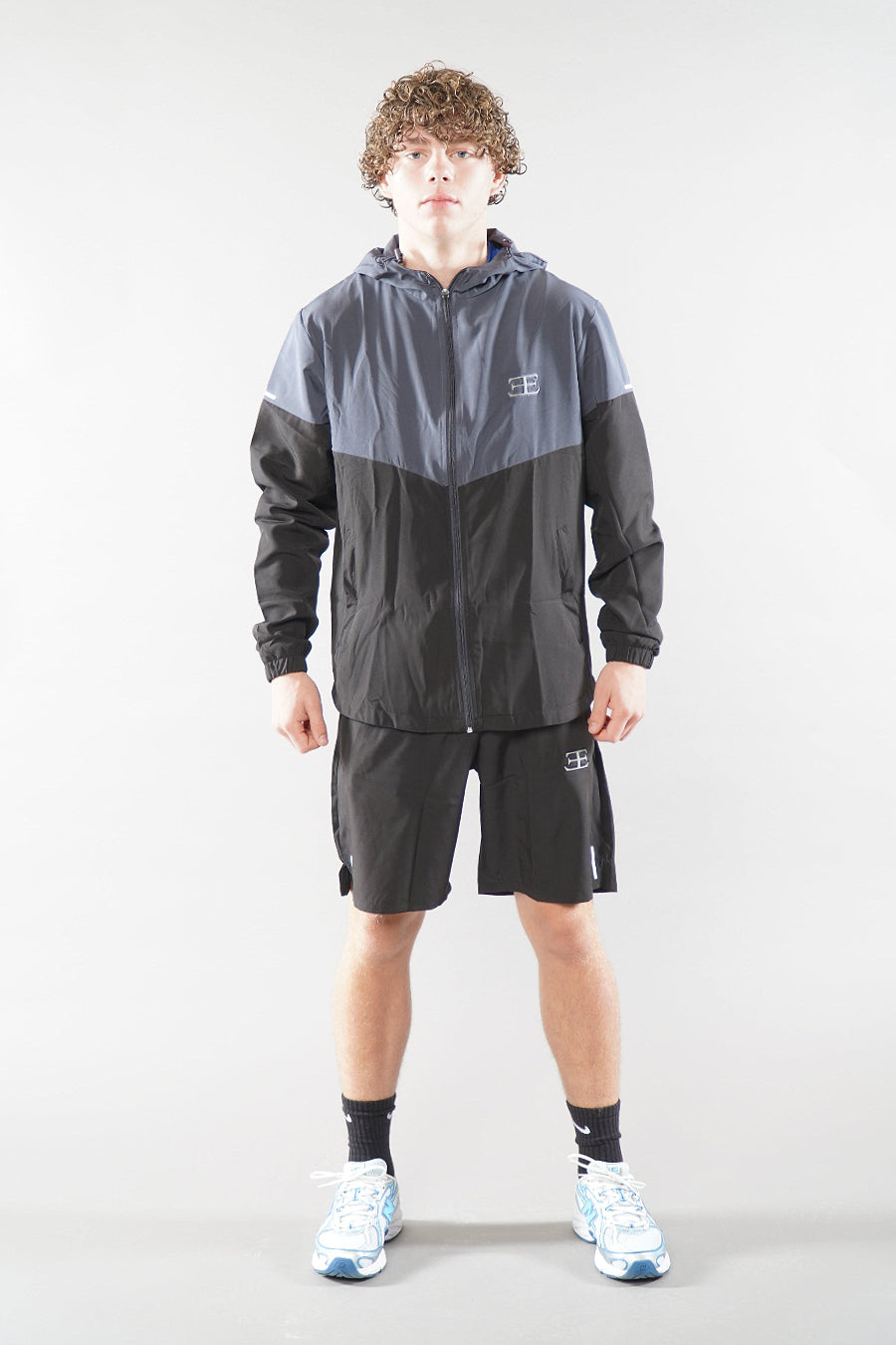 man wearing Elegante Black and grey Gym Shorts, and tracksuit jacket activewear for men, 