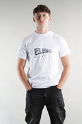 man wearing Elegante logo T-Shirt in white with black denim jeans on white background
